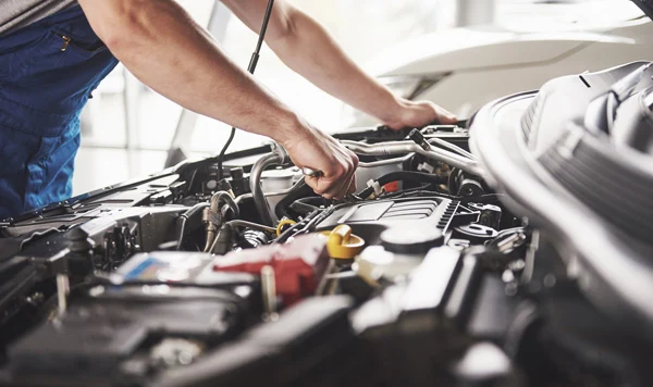 Technician working on a vehicle’s engine